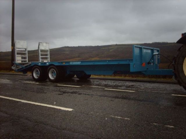 4 blue low loader on tractor